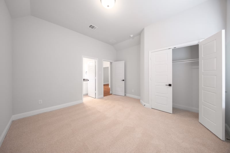 guest bedroom with carpet and walk-in closet