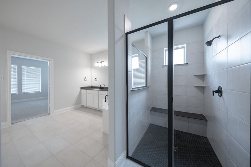 spacious primary bathroom with walk-in shower