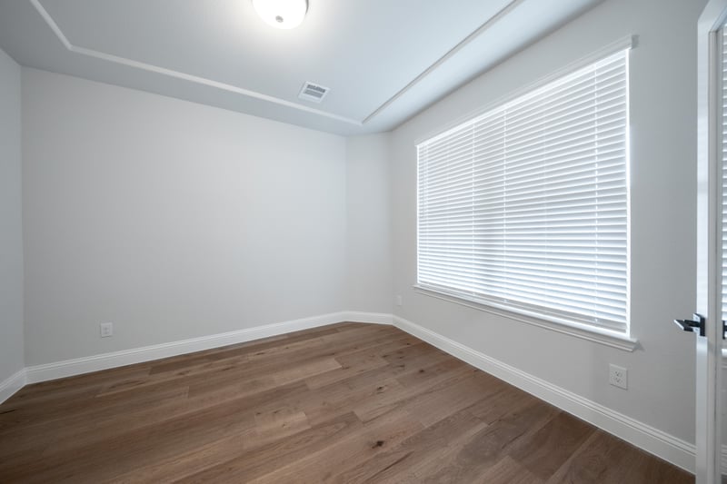 spacious study with hardwood flooring and window