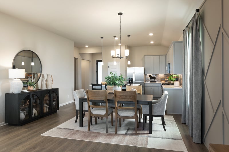 dining area with brown flooring, window & chandelier