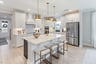 kitchen with white cabinets, white countertops, and gold accents