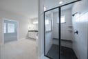 spacious primary bathroom with walk-in shower