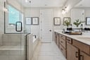 primary bathroom with a bathtub, a walk-in shower, and white tile flooring