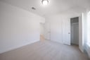 guest bedroom with carpet and walk-in closet