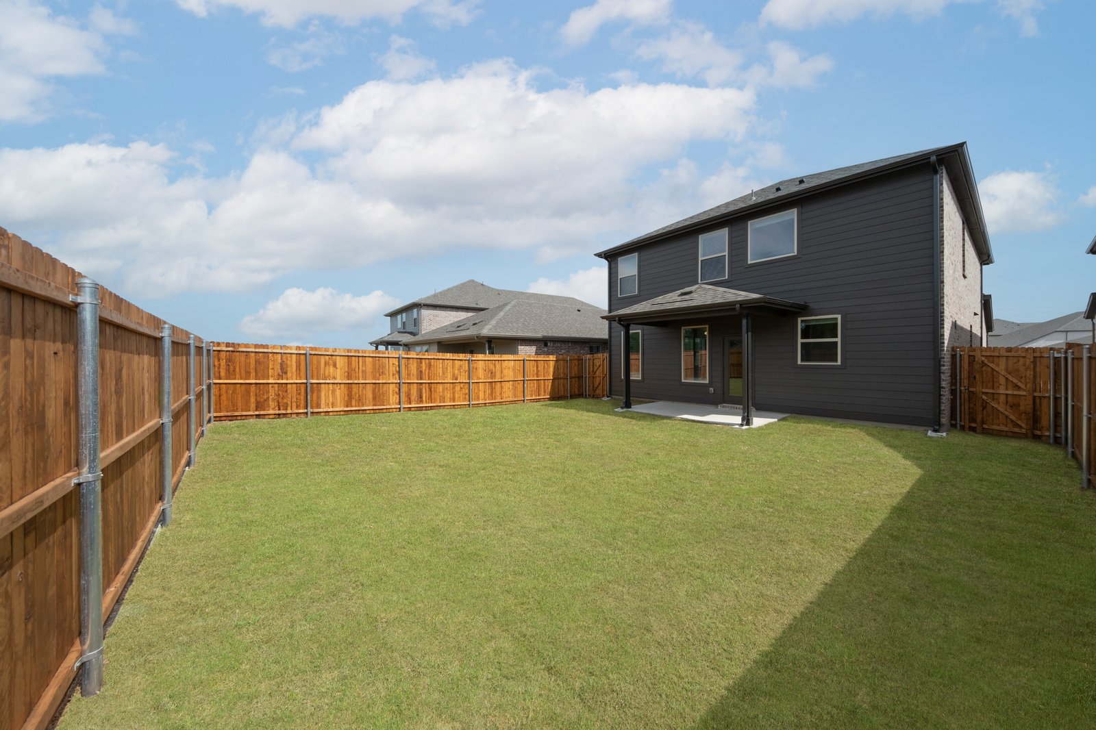 backyard with grass and covered patio