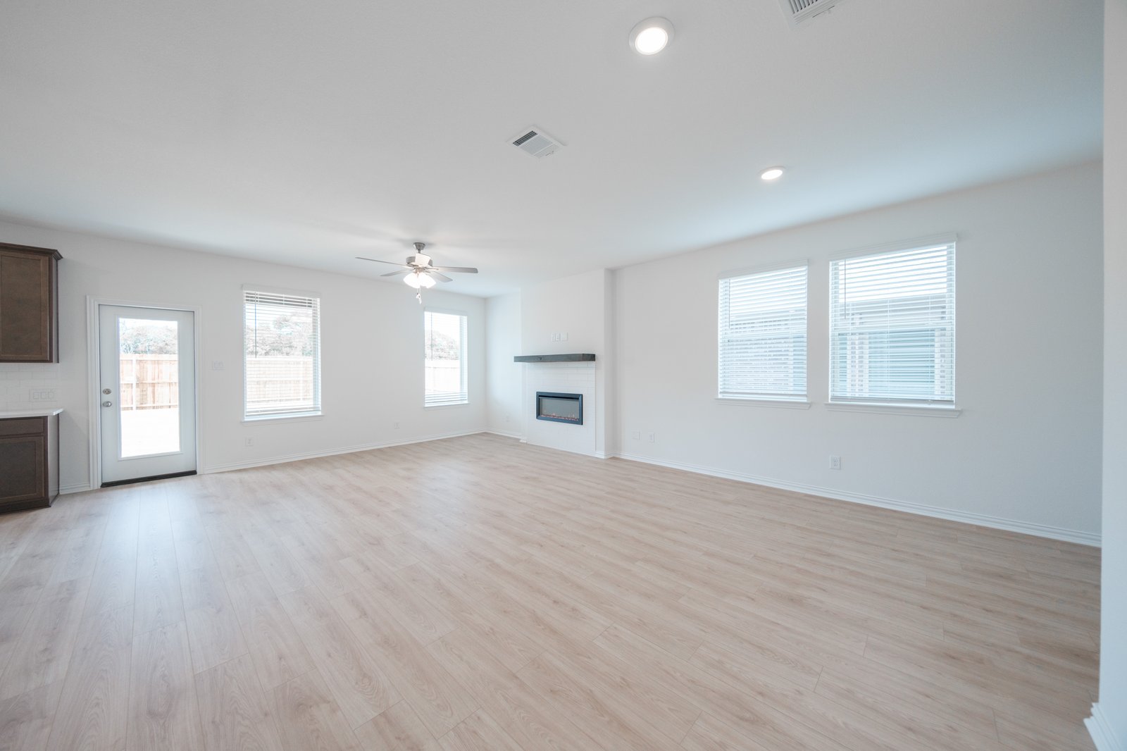 open great room with wood floors and fireplace