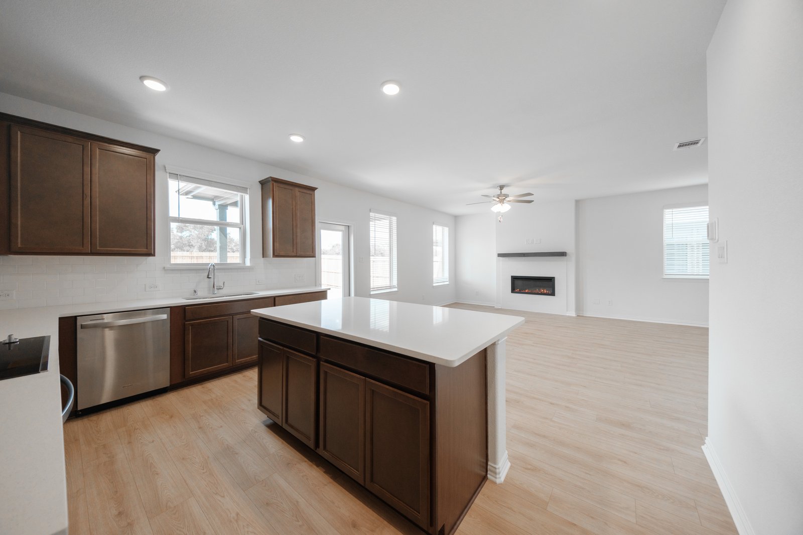 open kitchen with wood floors and island