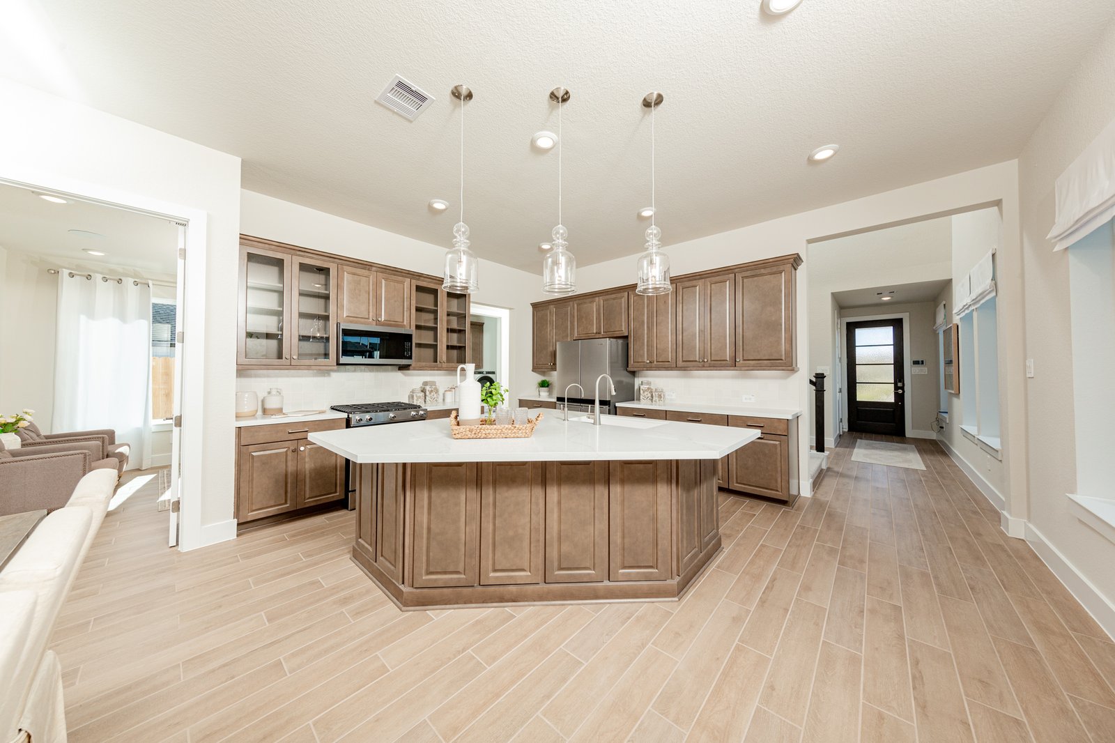 spacious kitchen with brown cabinets and hardwood flooring