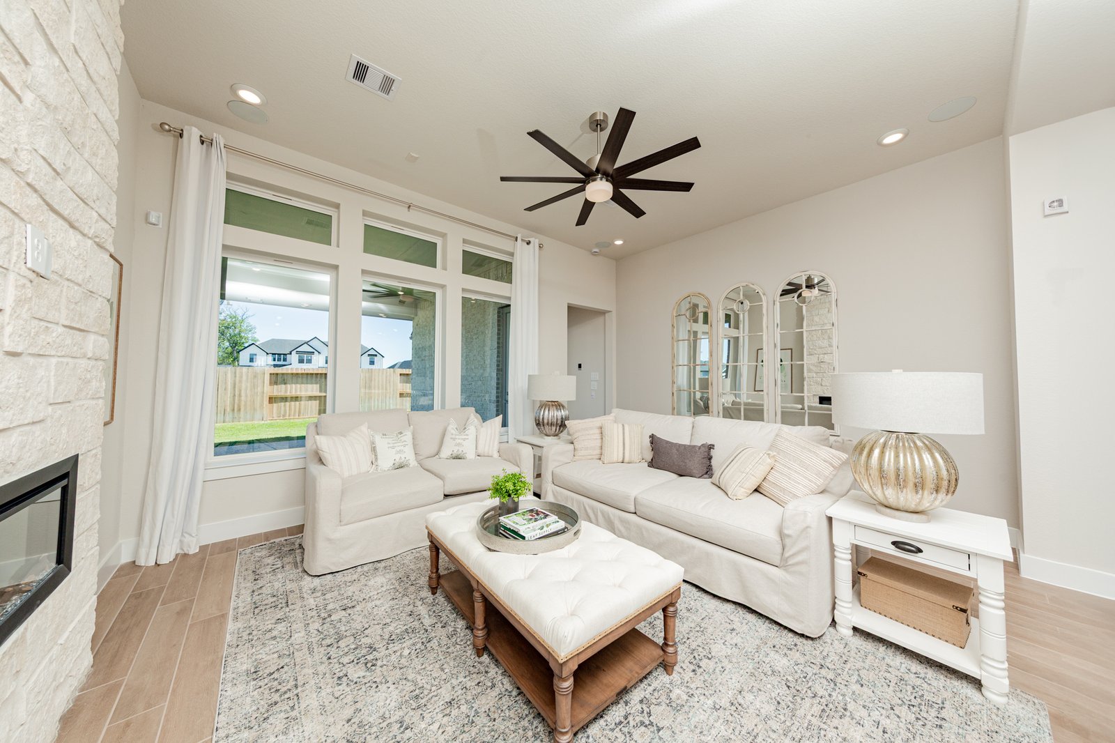open great room with fireplace and windows