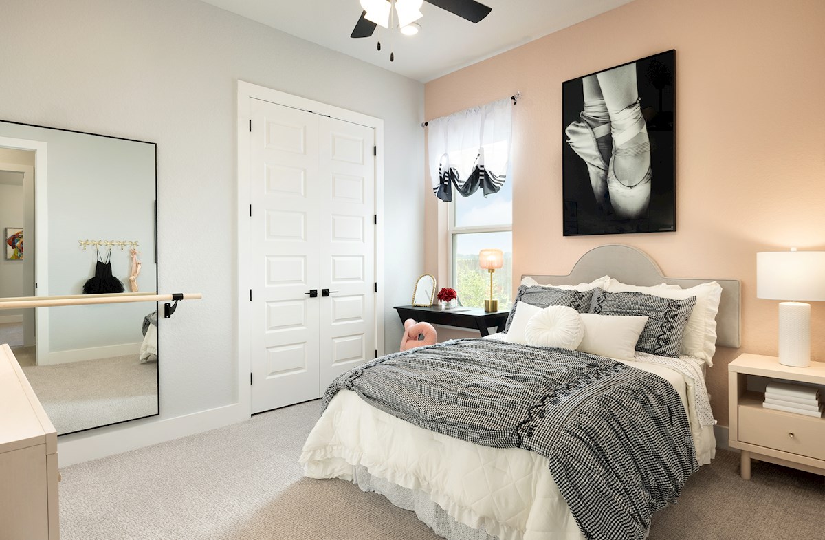 bedroom with carpet, ceiling fan & a window