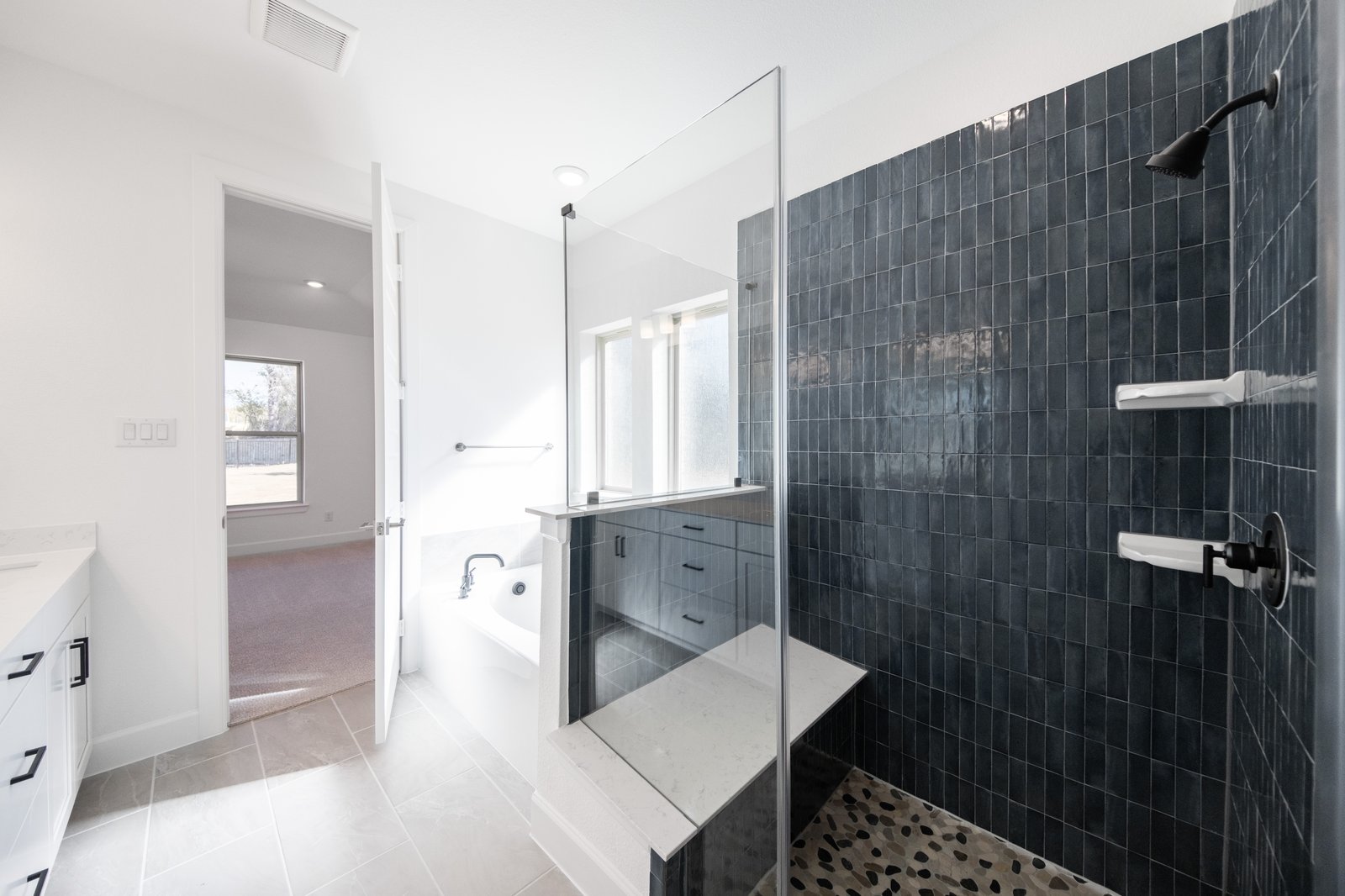 bathroom with walk-in shower with glass and tile