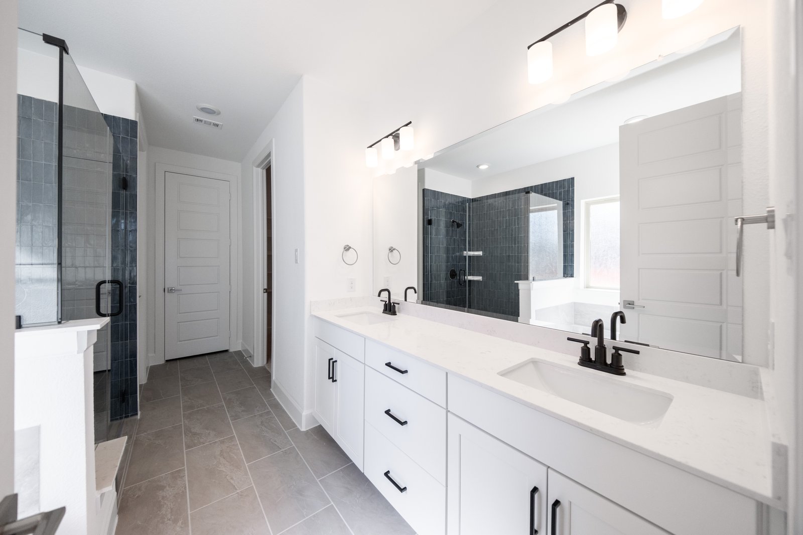bathroom with white countertops and white cabinets