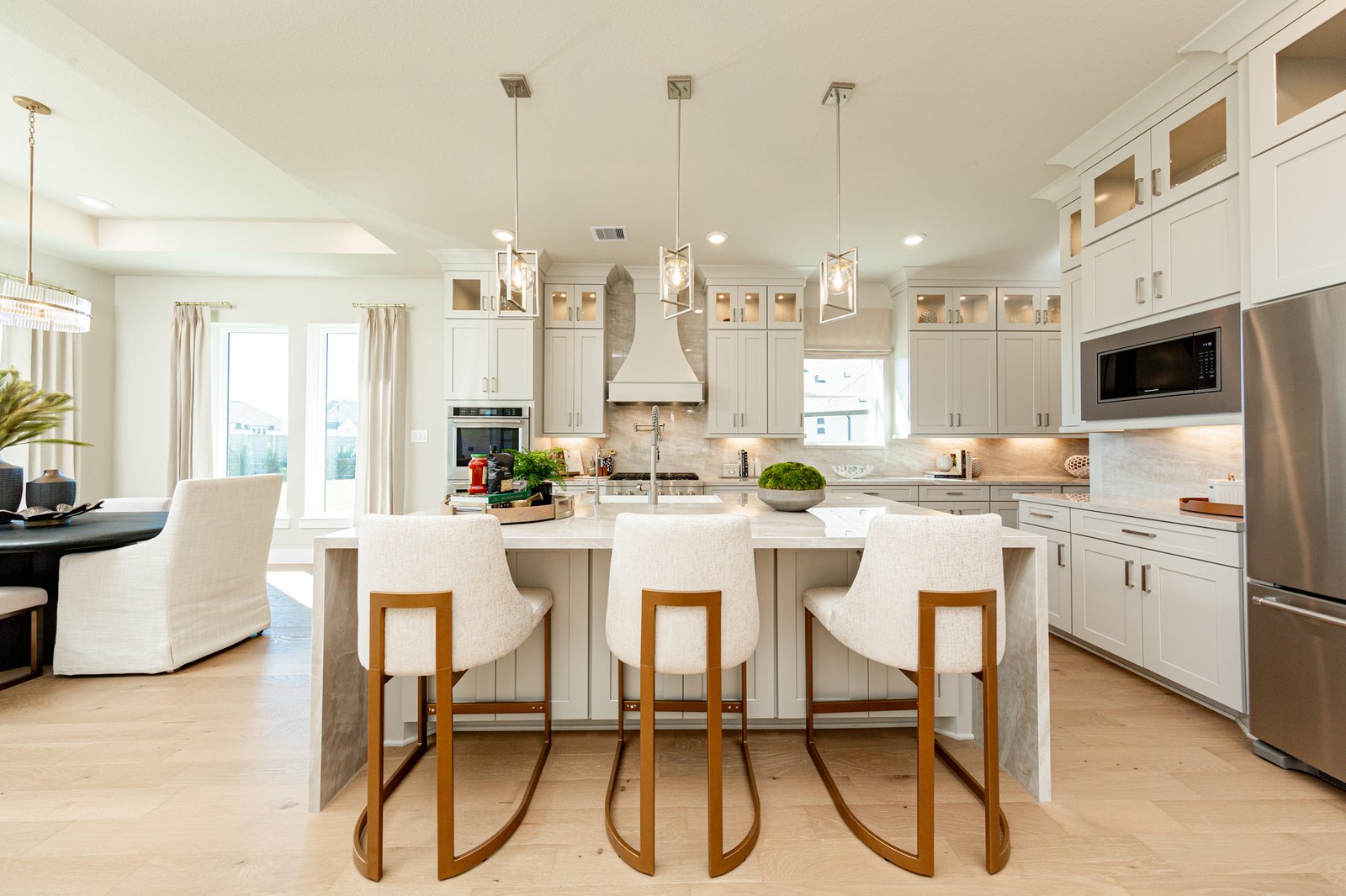 open kitchen with white cabinets and hardwood flooring
