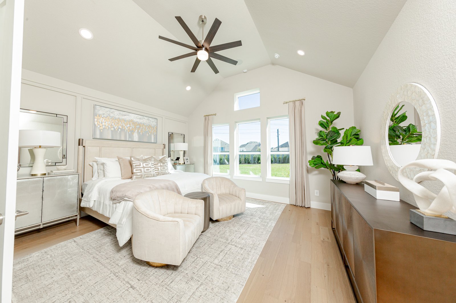 spacious primary bedroom with vaulted ceilings