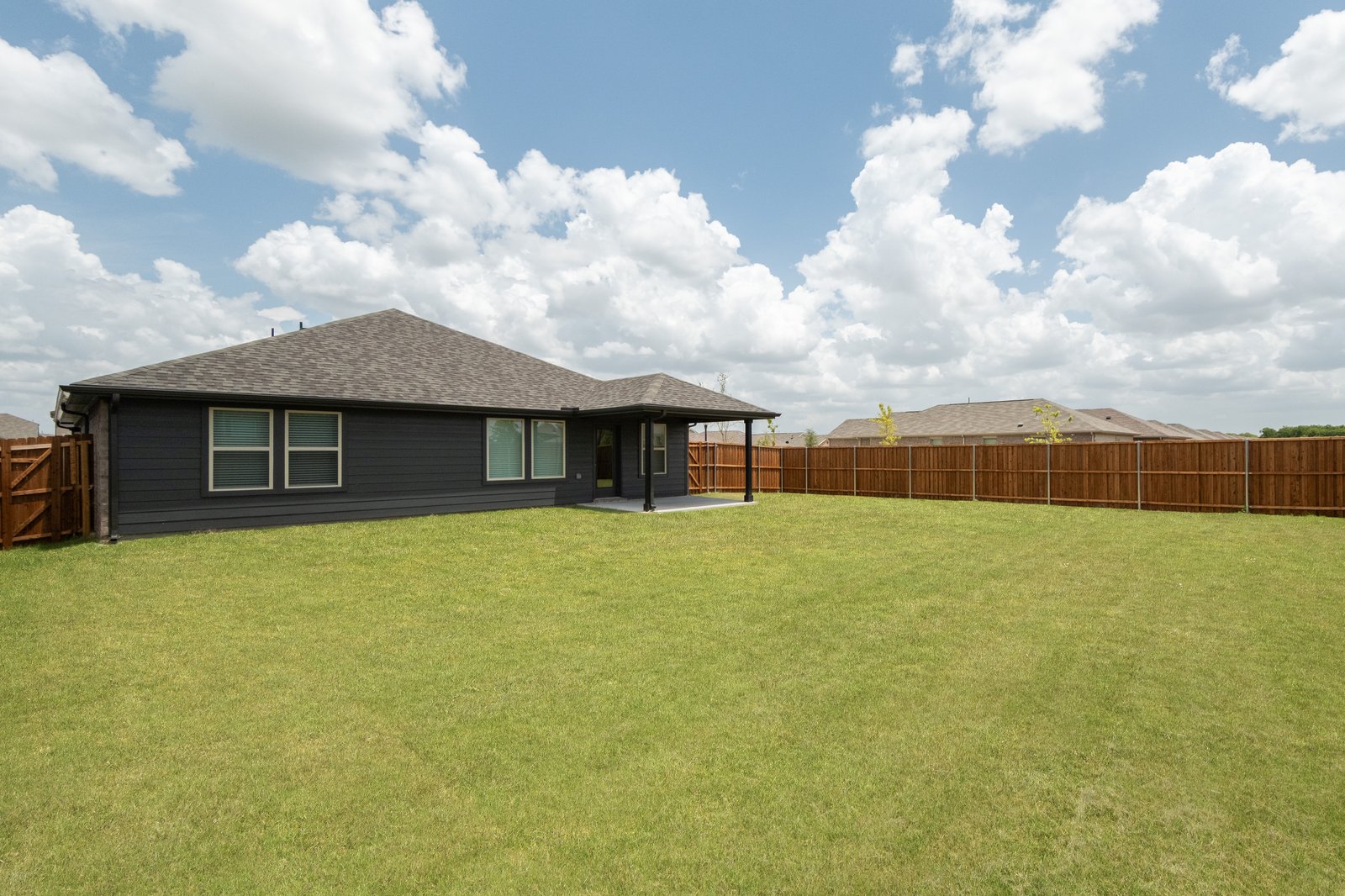 backyard with grass and covered patio