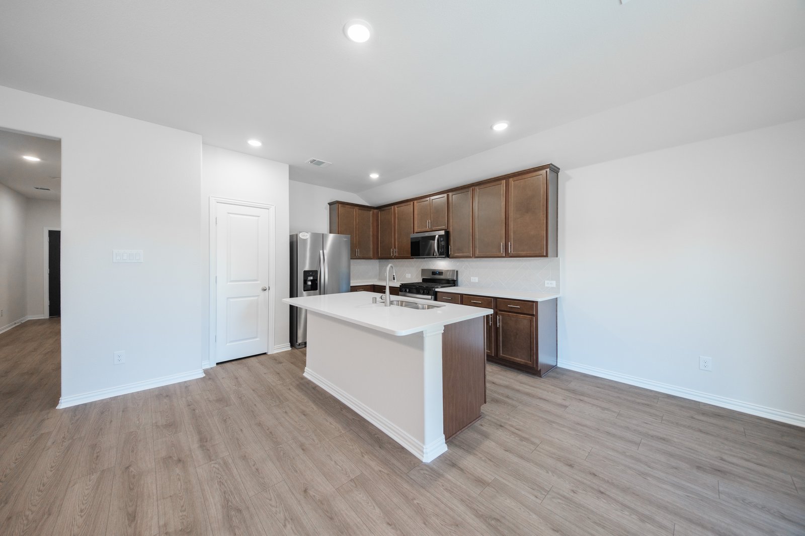 open kitchen with wood floors and island