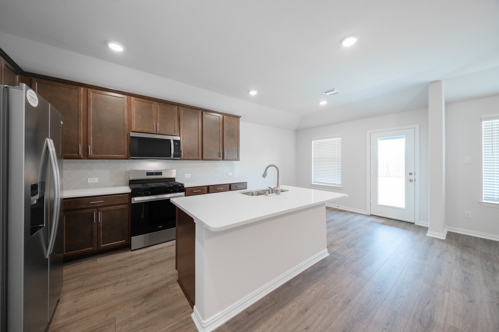 open kitchen with wood floors and island