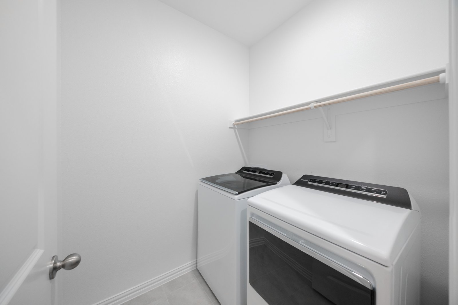 laundry room with tile floors, washer, and dryer