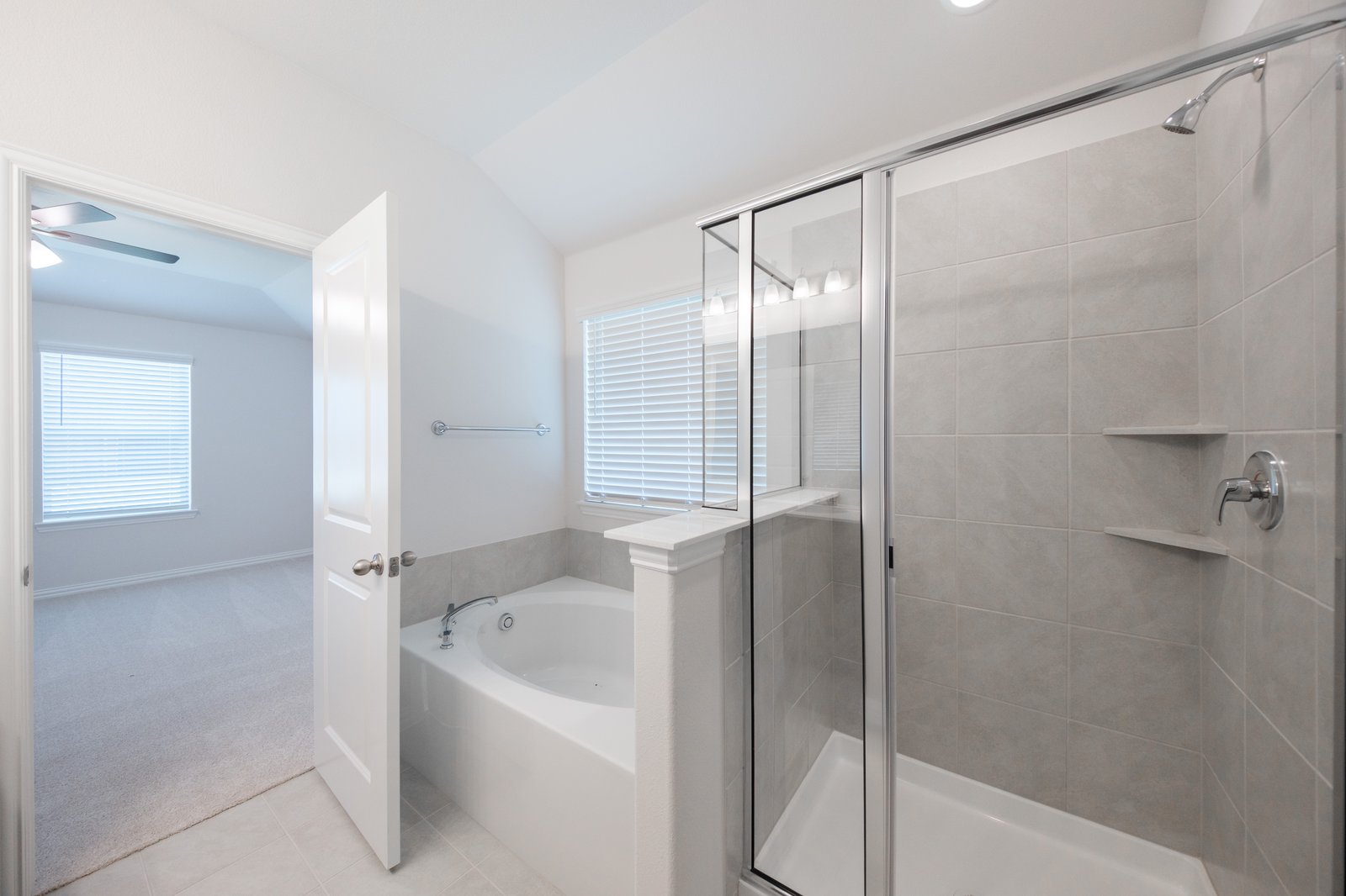 primary bathroom with soaking tub and walk-in shower