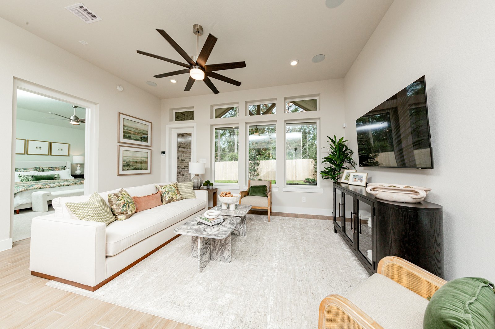 great room with tall ceilings and ceiling fan