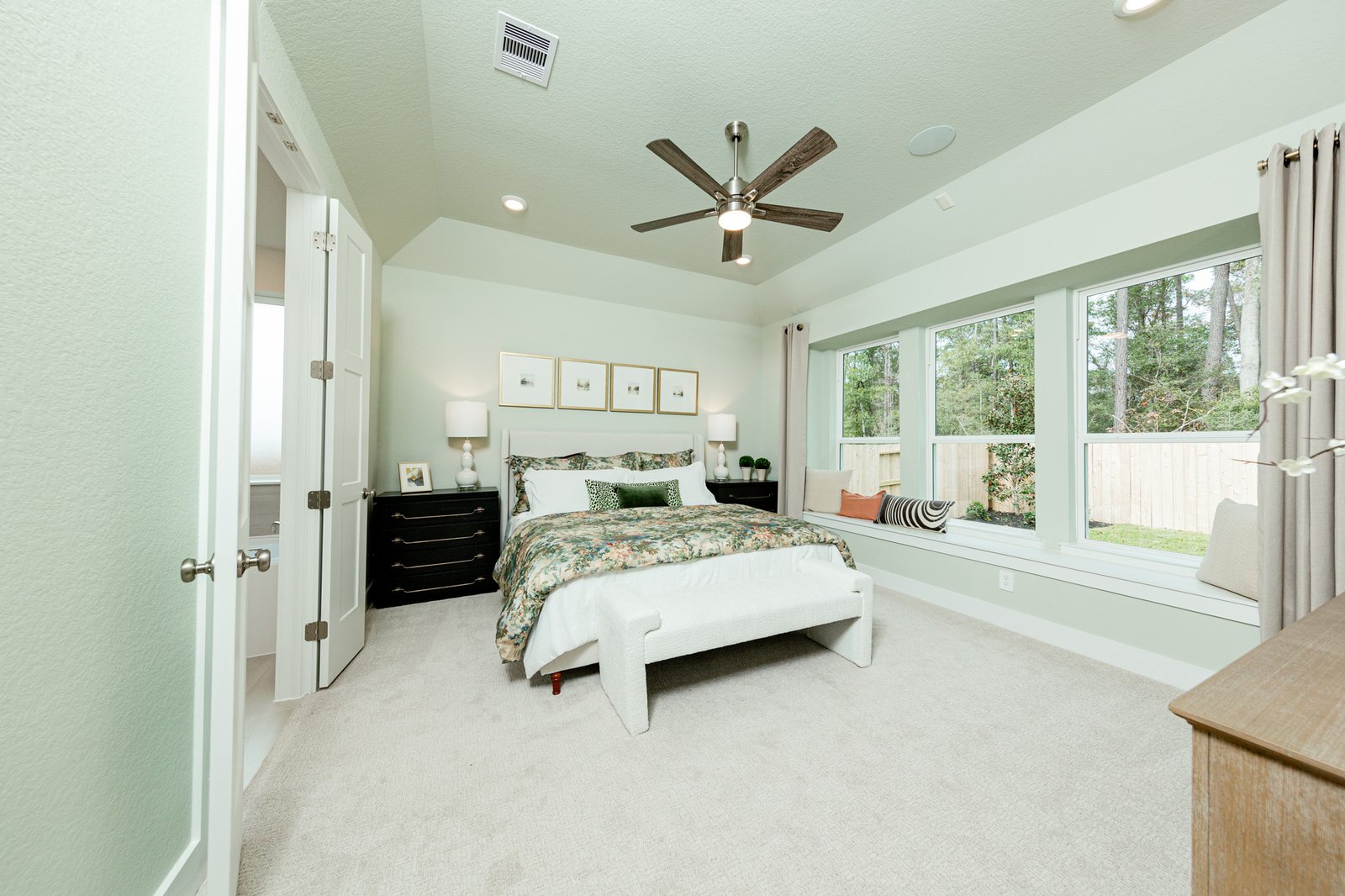 spacious primary bedroom with carpet and tall ceilings