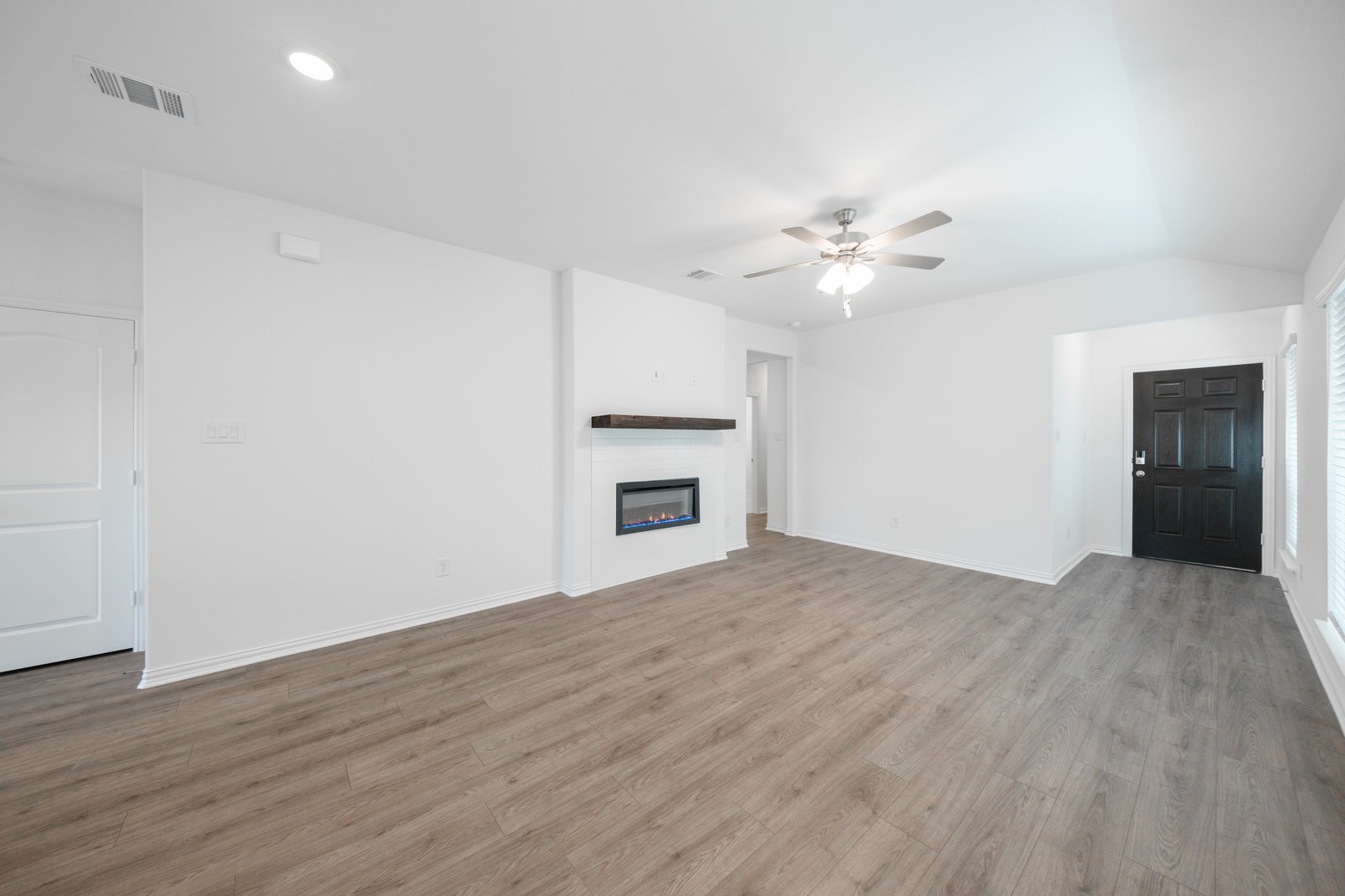 open great room with wood floors and fireplace