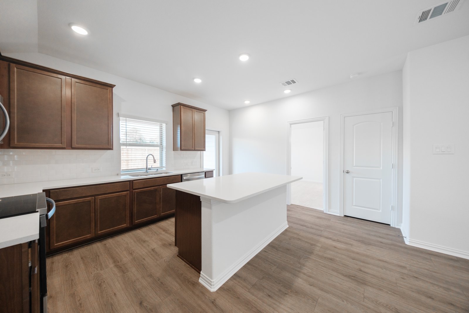open kitchen with wood floors and island