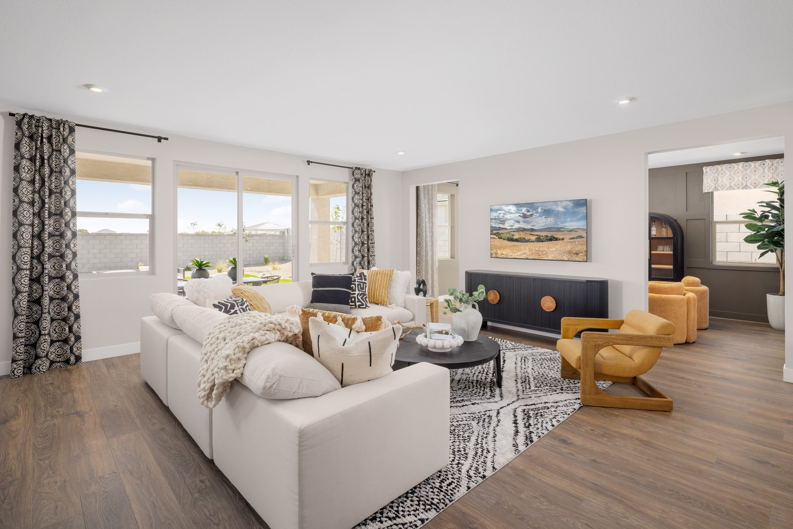 open-concept great room with large white couch and white rug