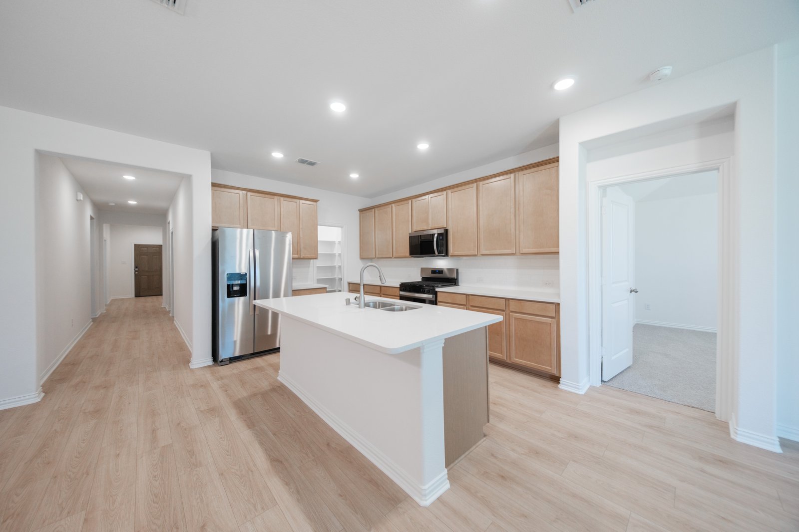 open kitchen with wood floors and island