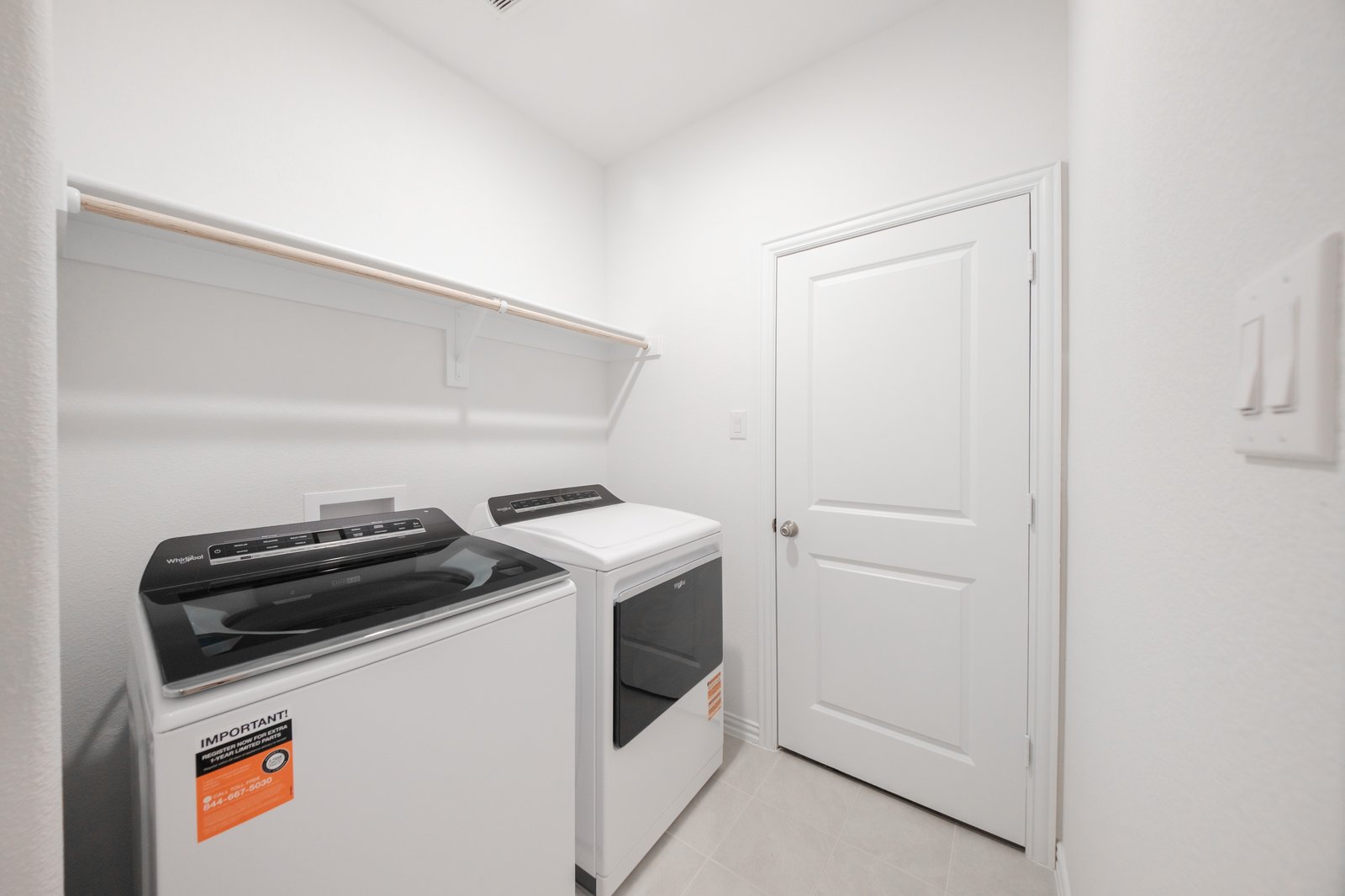 laundry room with tile floors, washer, and dryer