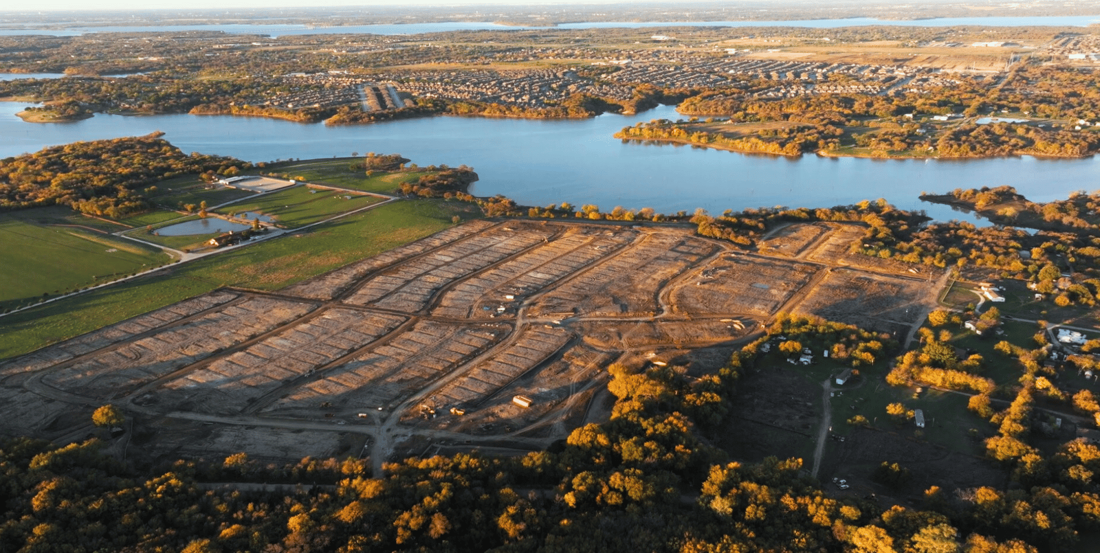 aerial view of single-family homes and lake