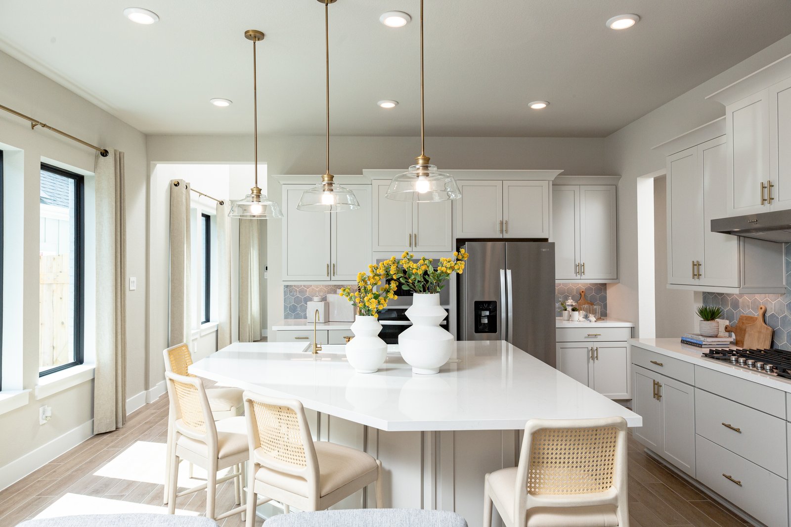 spacious kitchen with beige cabinets and island