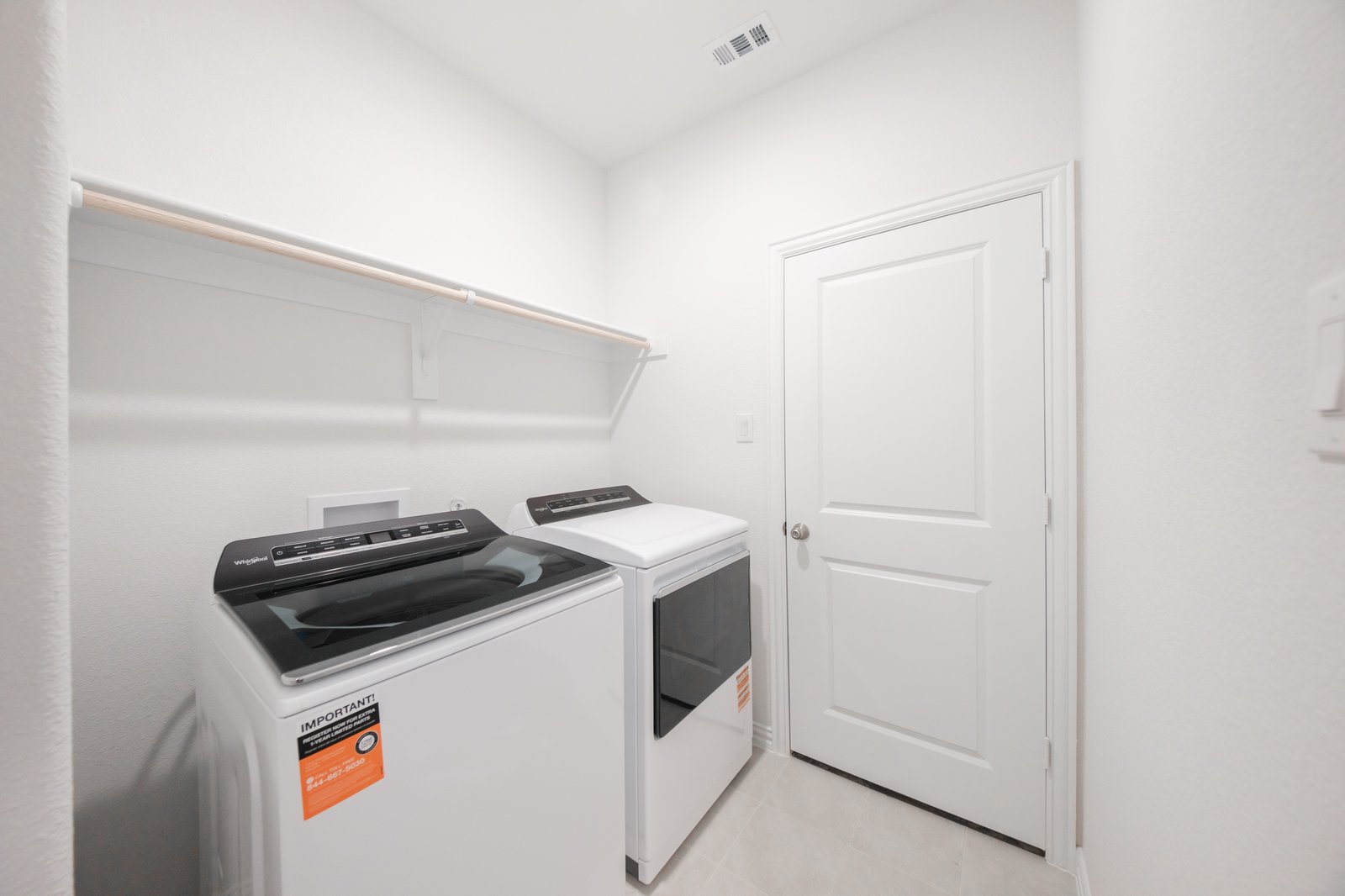 laundry room with tile floors, washer, and dryer