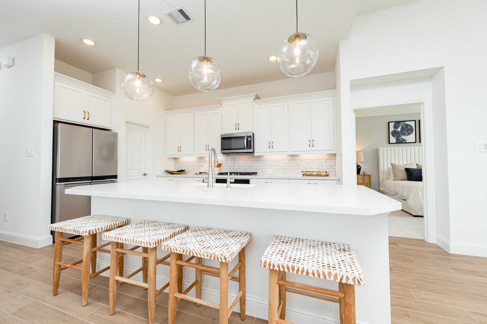 open kitchen with white cabinets and hardwood flooring