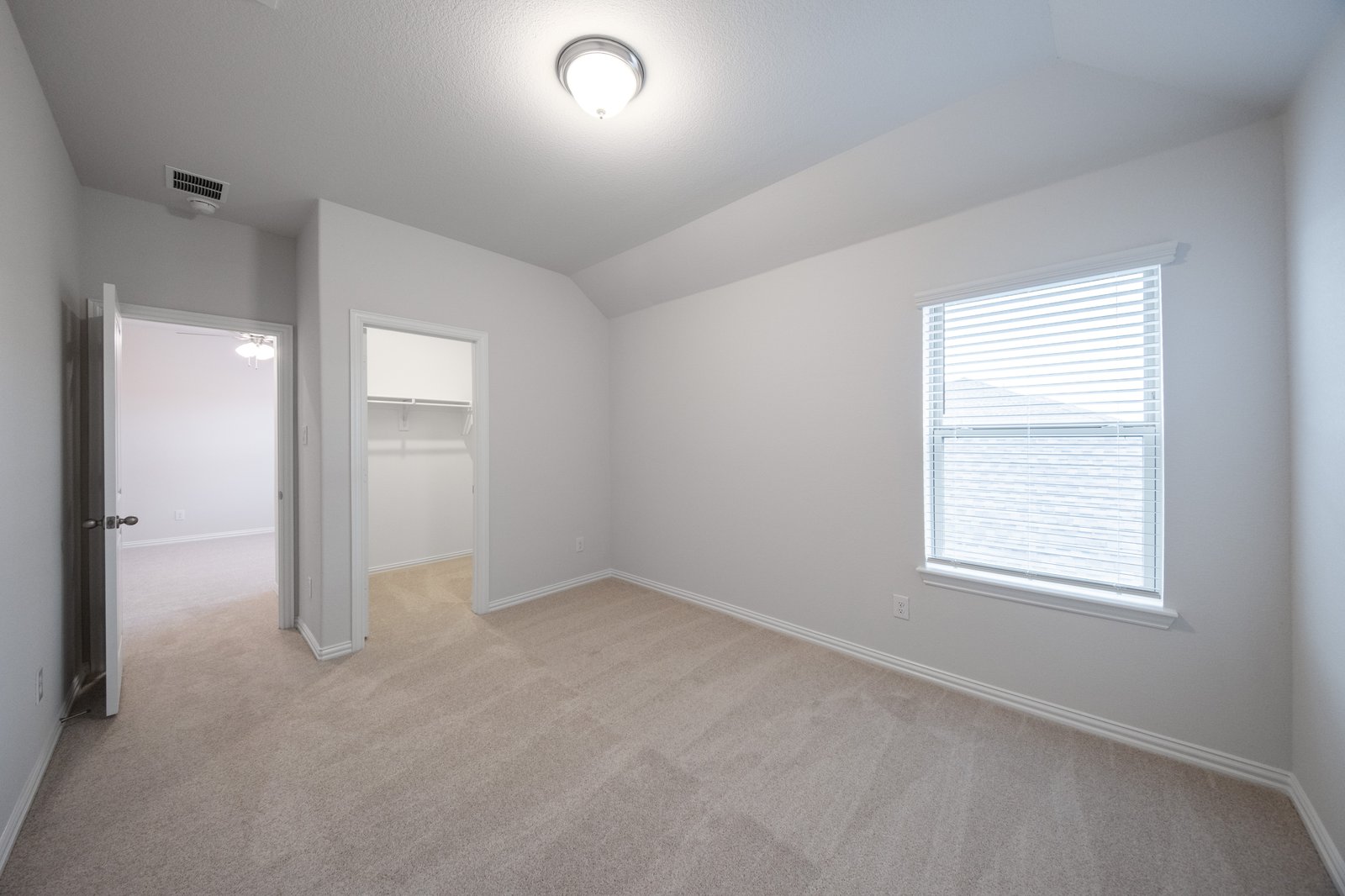 bedroom with carpet and window with blinds