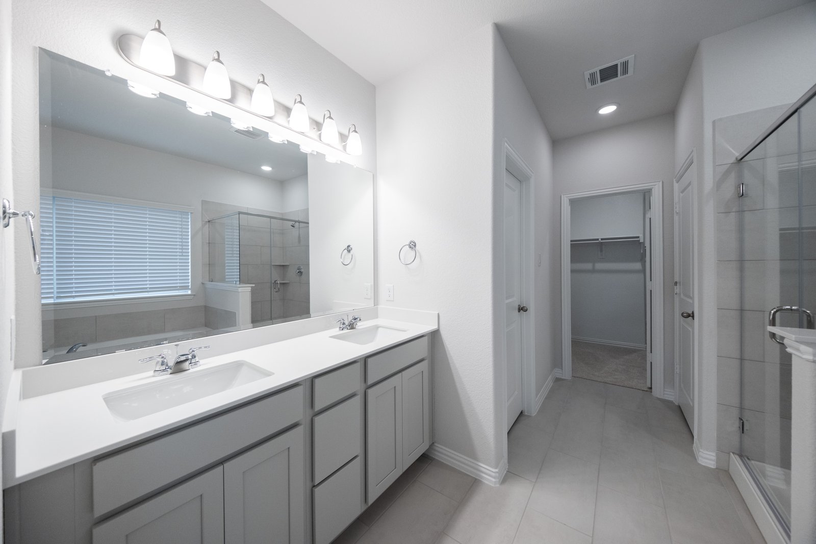 bathroom with white countertops and two sinks