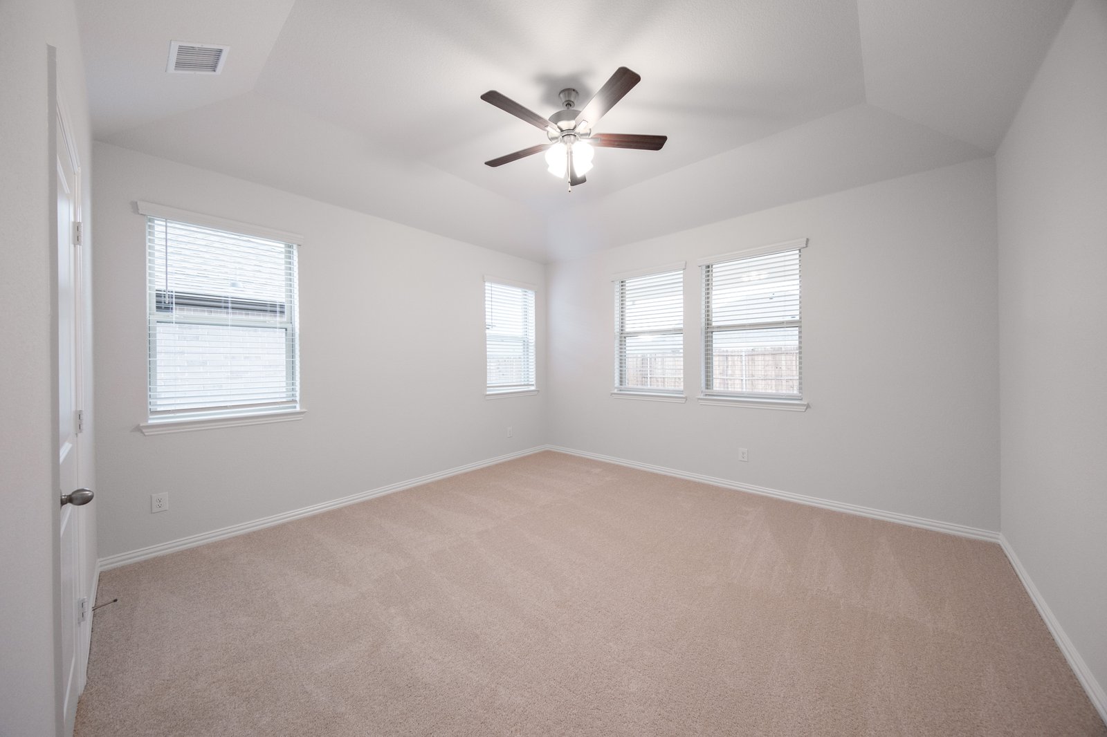 bedroom with windows with blinds