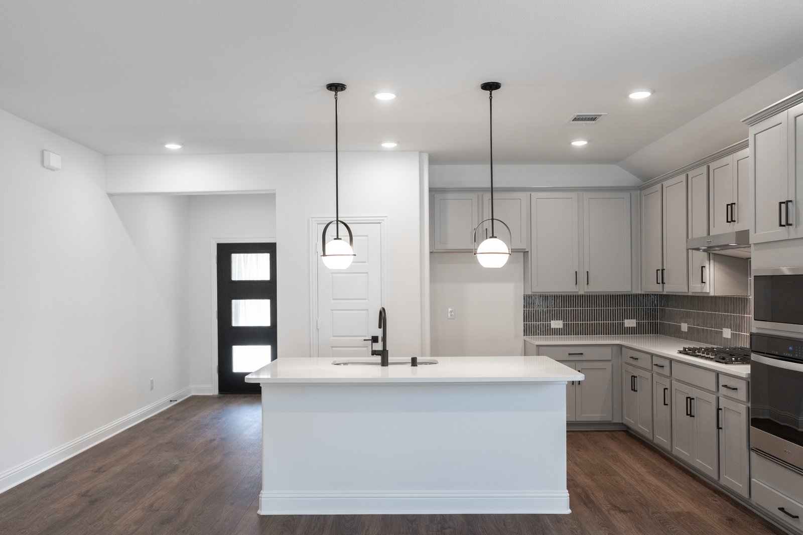 open kitchen with wood floors and island