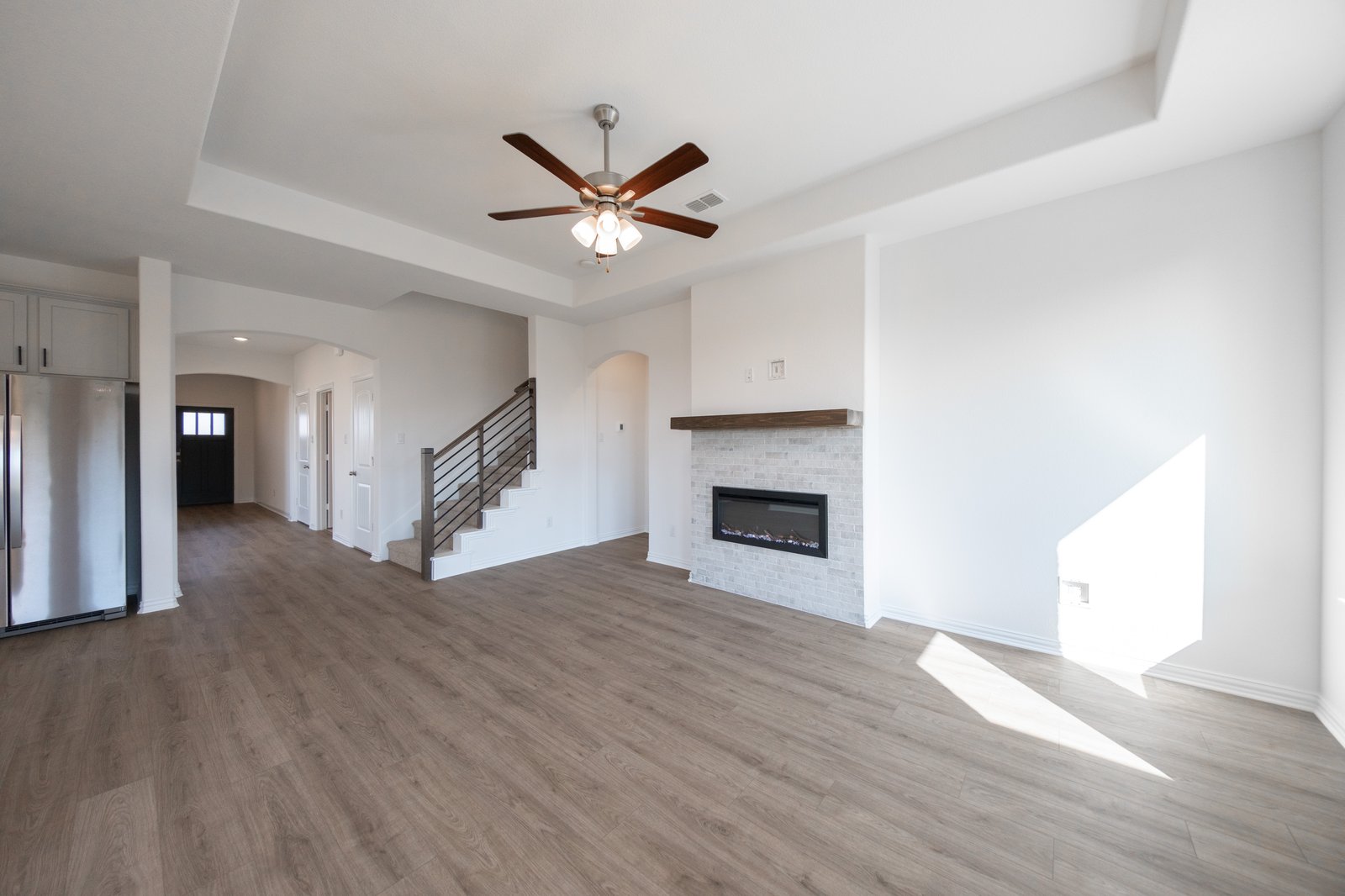 open great room with hardwood flooring and electric fireplace