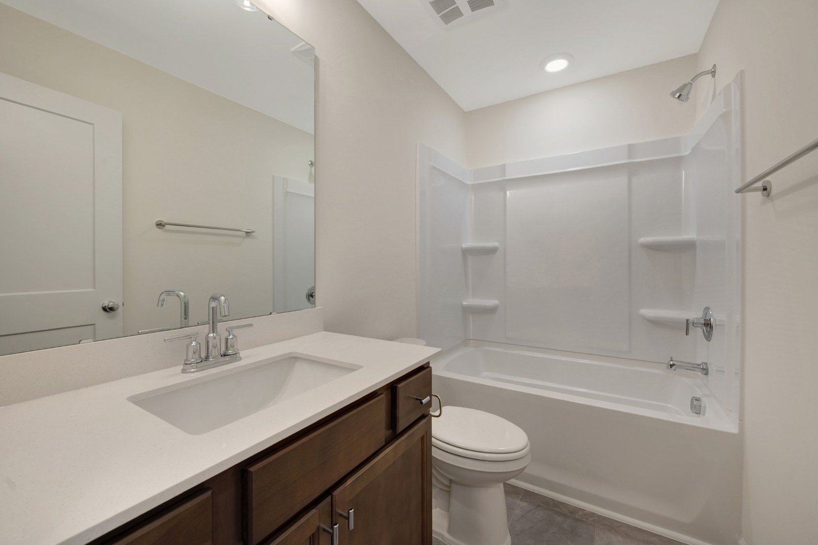 secondary bath with a shower and tub combo