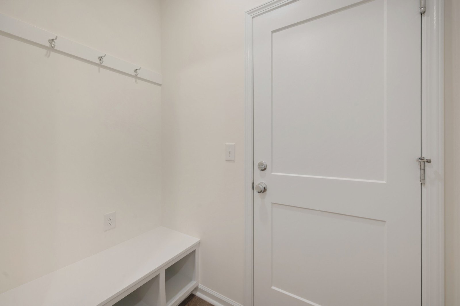 mudroom with a bench with cubbies and hooks