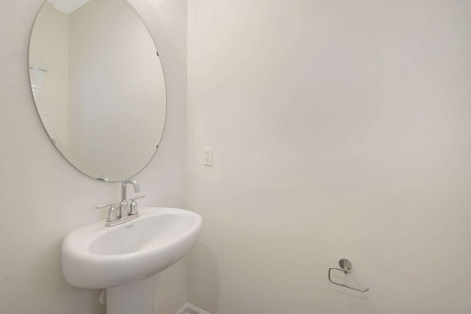 powder room with an oval mirror
