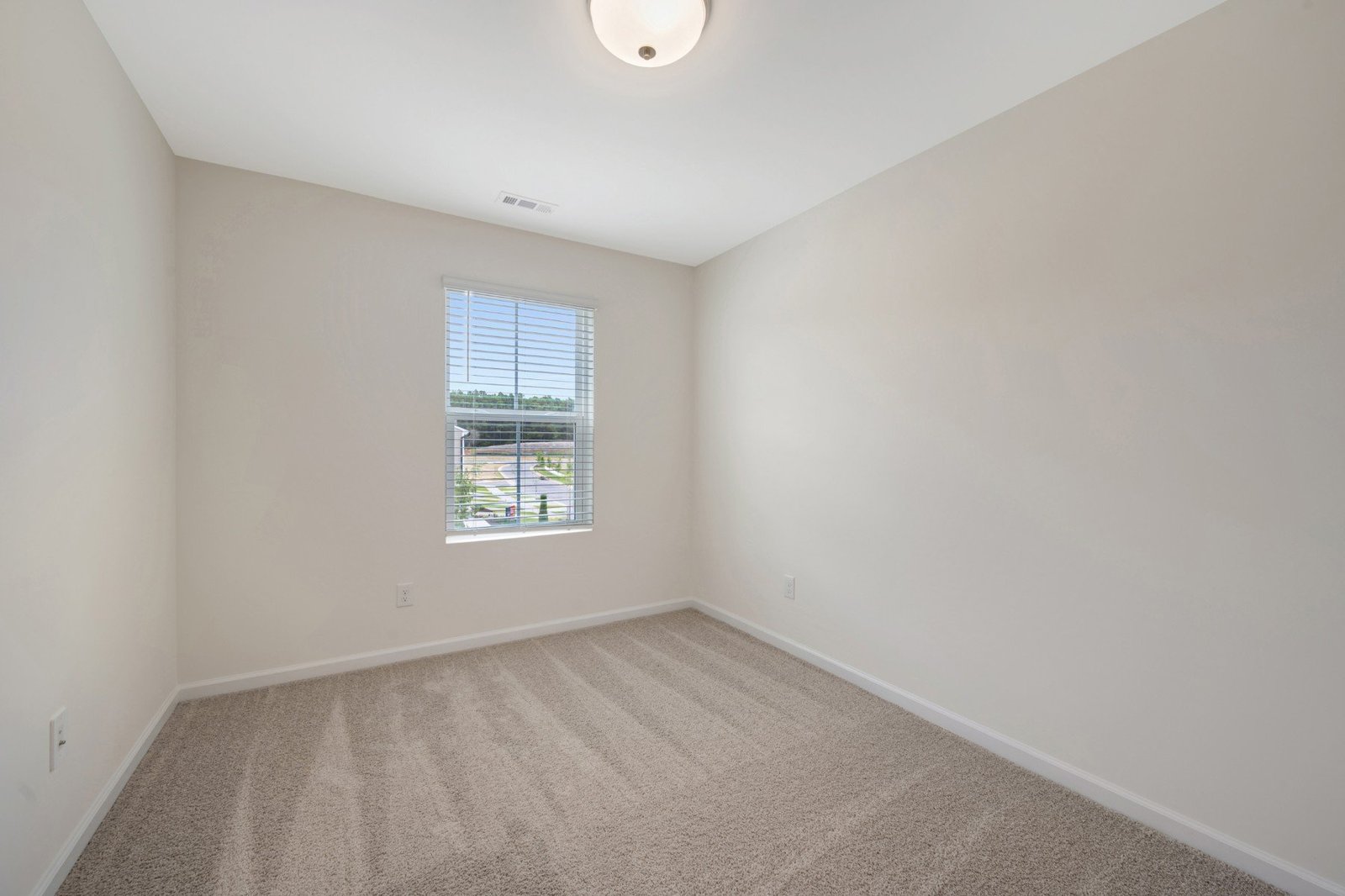 secondary bedroom with a window