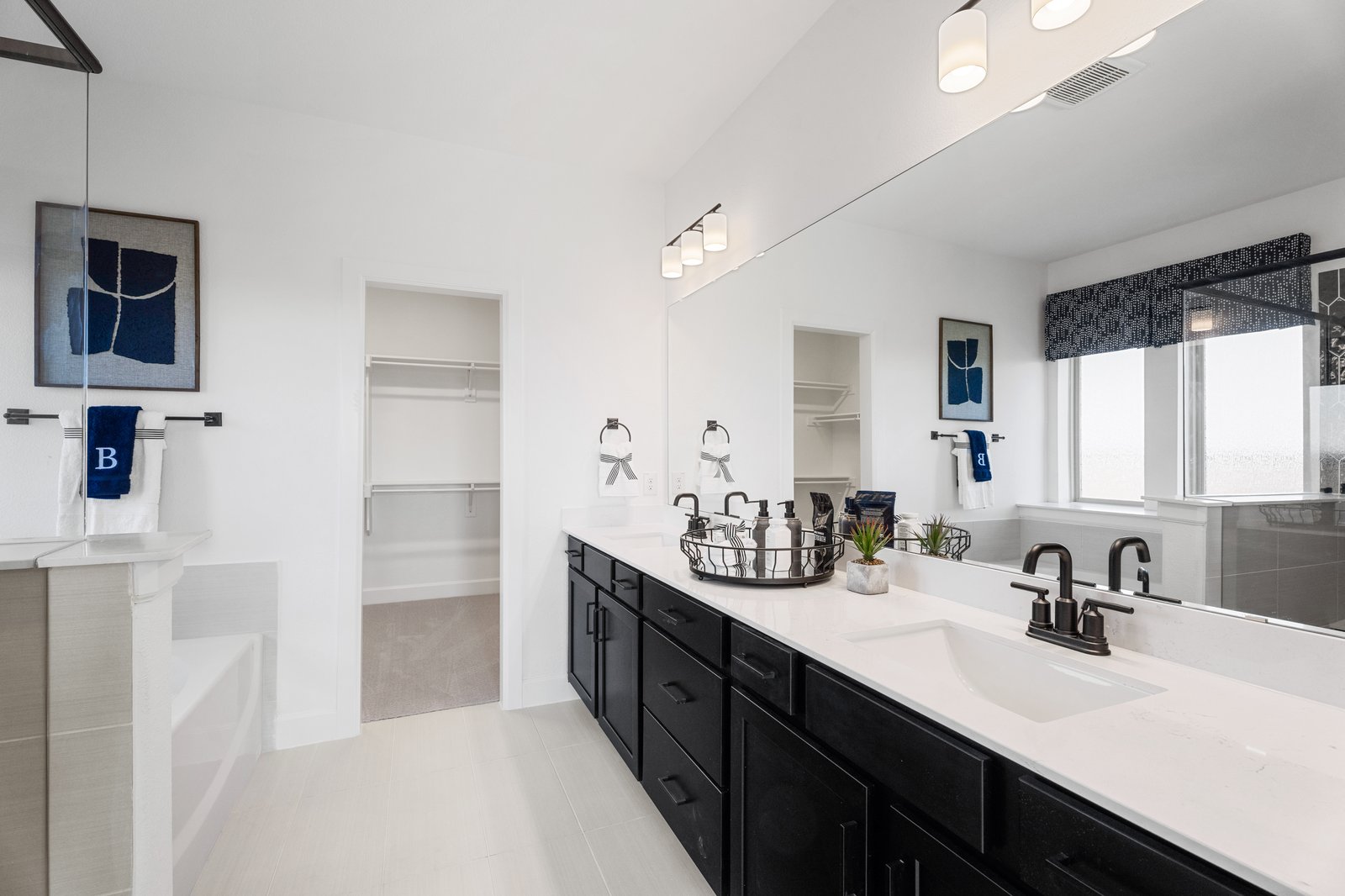 bathroom with large mirror and white countertops