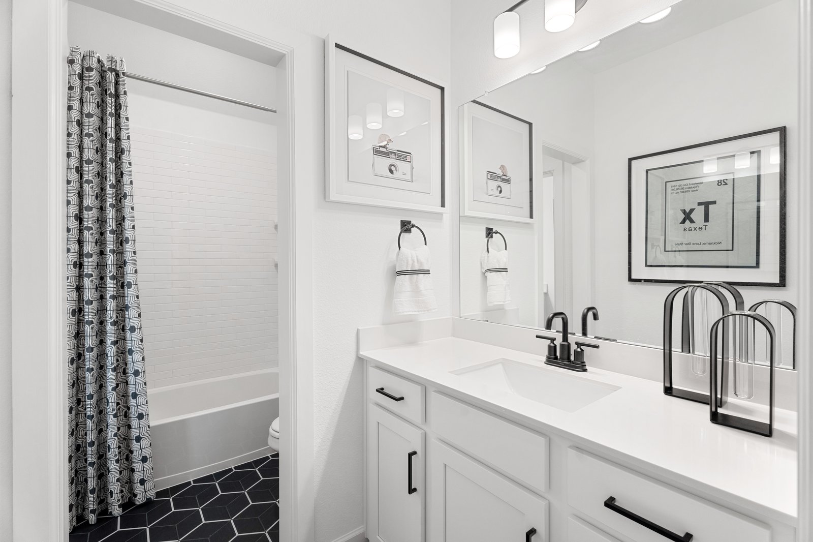 bathroom with white cabinets and countertops
