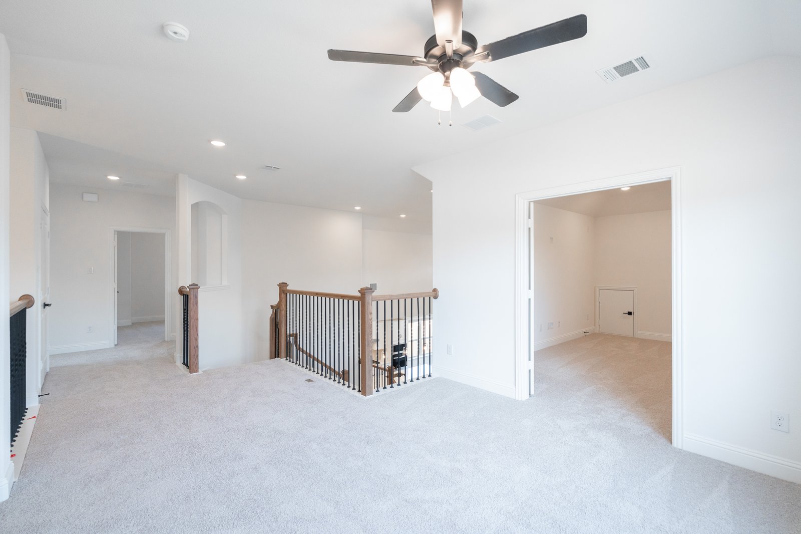 open gameroom with carpet and ceiling fan