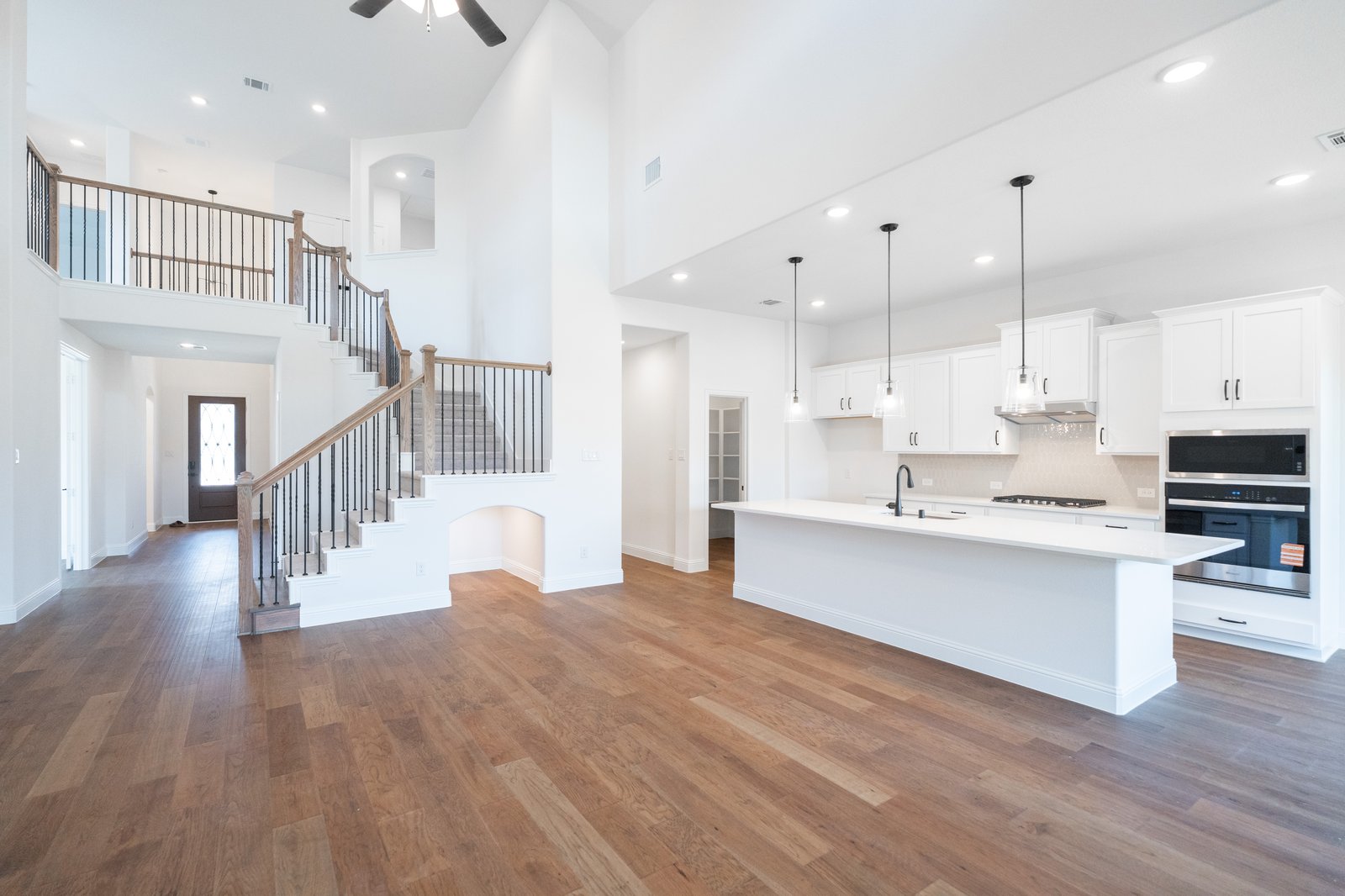 open great room with wood floors and fireplace