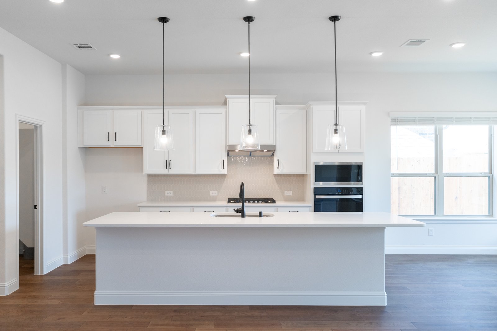 open kitchen with wood floors and island