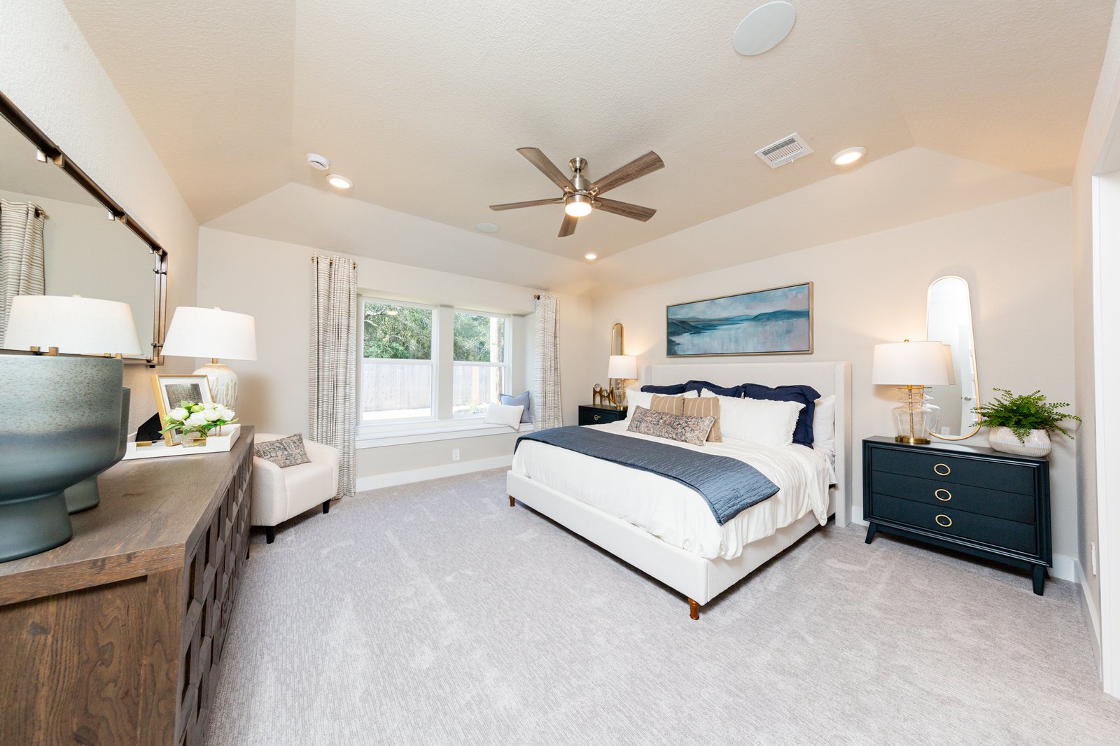 primary bedroom with high ceilings and carpet