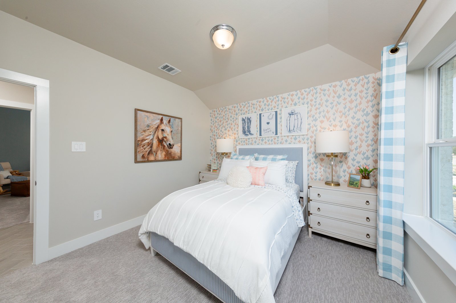 guest bedroom with window and carpet